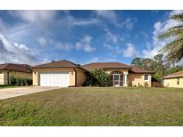 Charming one-story home featuring a well-manicured lawn and a two-car garage at 4966 Sunnyvale Rd, North Port, FL 34288