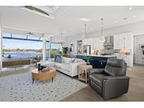 Open-concept living space with water views, modern kitchen, and stylish furnishings at 5 Reef Ct, Placida, FL 33946