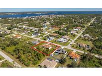 Aerial view showcasing the property's location within a beautiful, established neighborhood near the water at 5441 Farley St, Port Charlotte, FL 33981