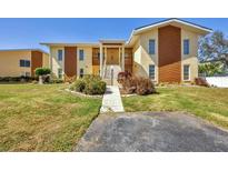 Inviting two-story condo building with well-manicured lawn, walkway, and charming curb appeal at 6699 San Casa Dr # Q3, Englewood, FL 34224