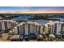 Beautiful condominium complex featuring multi-story buildings and scenic waterfront views at sunset at 13313 Gasparilla Rd # 404, Placida, FL 33946