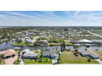Beautiful community of waterfront homes with boat docks and scenic canal access under a sunny blue sky at 15652 Ruston Cir, Port Charlotte, FL 33981