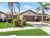 Charming single-story home featuring a well-manicured lawn, mature landscaping, and a spacious driveway leading to a two-car garage at 19241 Serafina St, Venice, FL 34293