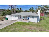 Charming single-story home with a well-maintained front yard and a cozy front porch at 8164 Archie St, Englewood, FL 34224