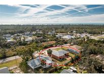 Lovely coastal home with an expansive yard, partially fenced-in, and lush greenery surrounding the property at 1080 Panda Rd, Venice, FL 34293