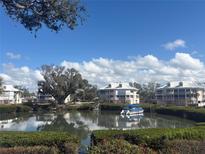Waterfront condos offer picturesque views, a private dock and access to boating on a sunny, cloud-filled day at 11000 Placida Rd # 702, Placida, FL 33946