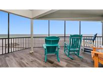 Relaxing balcony with ocean views and comfortable seating, perfect for enjoying the serene coastal atmosphere at 2820 N Beach Rd # 101, Englewood, FL 34223