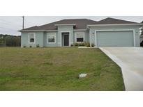 Charming single-story home with a well-maintained lawn and attached two-car garage at 6998 Dabarsky Ave, North Port, FL 34291