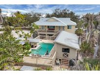 Inviting outdoor pool features swim-up bar and poolside cabana, perfect for entertaining and relaxation at 97 Kettle Harbor Dr, Placida, FL 33946