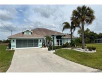 Charming single-Gathering home showcasing a well-manicured lawn, mature trees, and an attached two-car garage at 108 Fairway Rd, Rotonda West, FL 33947