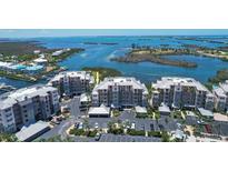 Beautiful aerial view of condos offering waterfront views, parking, and nearby amenities at 13313 Gasparilla Rd # C501 & Slip 11, Placida, FL 33946