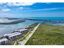 Stunning aerial view of condo complex with pristine waterfront access and vibrant surrounding scenery at 1651 Beach Rd # 311, Englewood, FL 34223