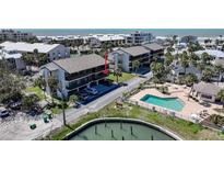 Lovely condo exterior features a pool, water access, and convenient covered parking at 2727 N Beach Rd # 113, Englewood, FL 34223