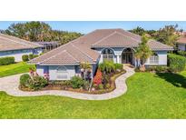 Beautiful single-story home featuring a well-manicured lawn, lush landscaping and a tile roof at 3615 Pennyroyal Rd, Port Charlotte, FL 33953