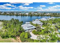 Stunning aerial view of waterfront homes with lush landscaping and beautiful waterfront access at 38 Seawatch Lake Dr, Boca Grande, FL 33921