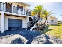 Charming condo featuring private garage, balcony, and welcoming black stairs leading to a cozy entrance at 4260 Placida Rd # 8D, Englewood, FL 34224