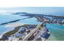 Stunning aerial view showcases beachfront condos near a serene pool and expansive ocean views at 6000 Boca Grande Cswy # D38, Boca Grande, FL 33921