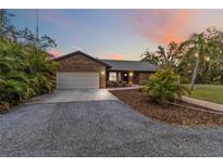 Charming brick home with mature landscaping and a spacious driveway offers curb appeal at 746 Brentwood Dr, Venice, FL 34292