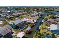 Waterfront home with screened pool, boat lift, and dock on canal with access to Gulf of Mexico at 1052 Newton St, Englewood, FL 34224