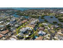 Aerial view of the home highlighting its waterfront location, screened-in pool, and neighborhood at 1052 Newton St, Englewood, FL 34224