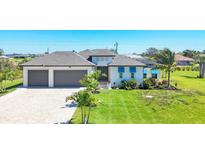 Beautiful single-Gathering home with a well manicured lawn and a two-car garage at 213 Sunset Rd, Rotonda West, FL 33947
