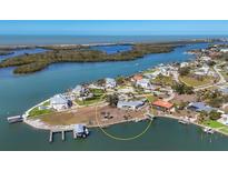 Gorgeous aerial view of the waterfront property featuring a boat dock, swimming pool and stunning landscape at 400 Anchor Row, Placida, FL 33946