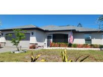 Charming single-story home with well-maintained lawn, landscape beds, and a two-car garage at 5388 Montego Ln, Port Charlotte, FL 33981