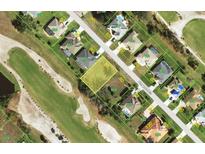 Aerial view of a residential property bordered by a golf course, showcasing a prime location at 65 Pinehurst Ct, Rotonda West, FL 33947