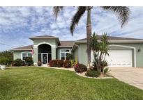 Charming single-story home boasts lush landscaping, a well-manicured lawn, and inviting curb appeal at 10082 Army Cir, Port Charlotte, FL 33981