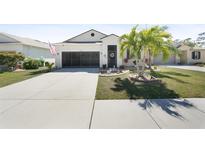 Charming single-story home featuring a two-car garage, landscaped yard, and well-maintained lawn at 10183 Winding River Rd, Punta Gorda, FL 33950