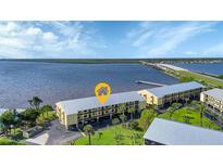 Waterfront condos featuring boat docks, lush lawns, and nearby bridge access at 14459 River Beach Dr # 129, Port Charlotte, FL 33953