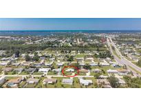 Wide aerial shot of neighborhood featuring charming home with lush lawn and mature landscaping at 1680 Meadow Lark Ln, Englewood, FL 34224