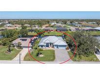 Beautiful single-story home with a well-manicured lawn and brick-paved driveway at 228 White Marsh Ln, Rotonda West, FL 33947