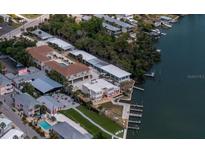 Stunning aerial view of waterfront property with docks, lush greenery, and community amenities at 2405 N Beach Rd # 10, Englewood, FL 34223