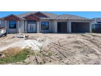 Under construction house with front door and two-car garage on a sunny day at 254 White Marsh Ln, Rotonda West, FL 33947
