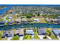 Stunning aerial view of waterfront homes and intersecting canals, perfect for boating, fishing and enjoying the Florida lifestyle at 9330 Migue Cir, Port Charlotte, FL 33981