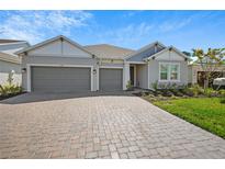 Beautiful one-story home featuring a 3-car garage and a charming brick driveway at 1607 Laurel Brook Ln, Port Charlotte, FL 33953