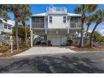 Charming raised beach house with brick driveway, garage, palm trees and rooftop terrace at 5000 Gasparilla Rd # Vh37, Boca Grande, FL 33921
