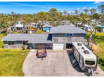 Inviting two-story home featuring an oversized driveway, two-car garage, and ample parking for your RV at 698 & West W Perry St, Englewood, FL 34223