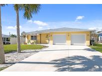 Charming single story home with a two car garage and a long concrete driveway at 840 Park Rd, Englewood, FL 34223