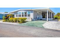 Charming home with well-kept landscaping, carport, and large windows at 985 Jolanda Cir, Venice, FL 34285