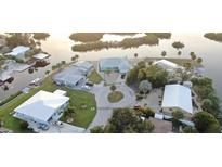 Stunning aerial view of waterfront homes, meticulously maintained lawns, and private boat docks at 1490 Janet Pl, Englewood, FL 34223