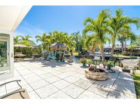 Backyard patio with fire pit, outdoor seating, and waterfront views at 1648 Shelburne Ln, Sarasota, FL 34231