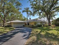 Charming single-story home featuring lush landscaping, a two-car garage, and a welcoming driveway at 220 Southampton Drive # 325, Venice, FL 34293
