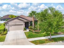 Charming single-story home with a well-manicured lawn and mature landscaping at 2572 Sherman Oak Dr, North Port, FL 34289
