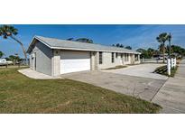 Well-maintained single-story home featuring an attached two-car garage and a paved driveway at 408 S Mccall Rd, Englewood, FL 34223