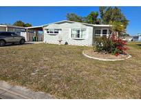 Charming single-story home with well-maintained lawn and simple landscaping in a sunny setting at 6162 Redwing Ave, Englewood, FL 34224