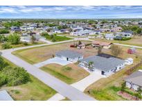 Beautiful aerial view of neighborhood homes with lush landscaping and a community featuring a pool at 10060 Amelia Ave, Englewood, FL 34224