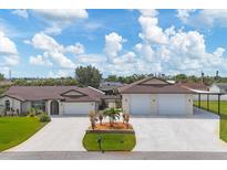 Inviting single-story home featuring a sprawling driveway and manicured lawn with a rear carport at 11101 Sandrift Ave, Englewood, FL 34224