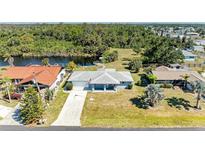 Charming one-story home with beautiful landscaping and a serene canal view at 1278 Lincoln Dr, Englewood, FL 34224
